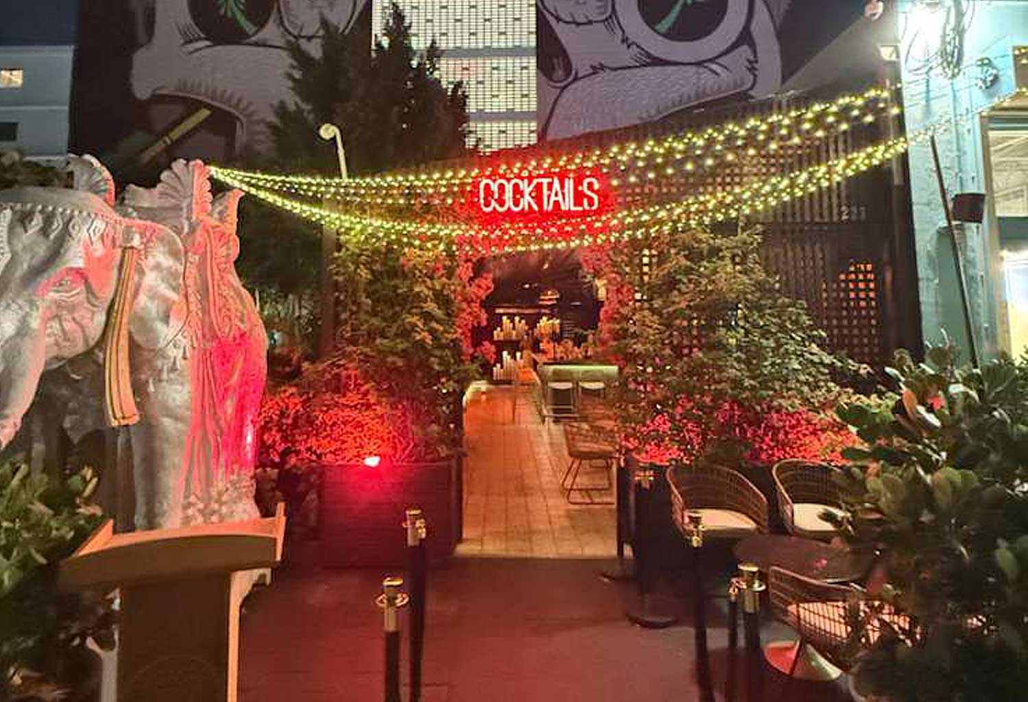 a room with a sign and plants