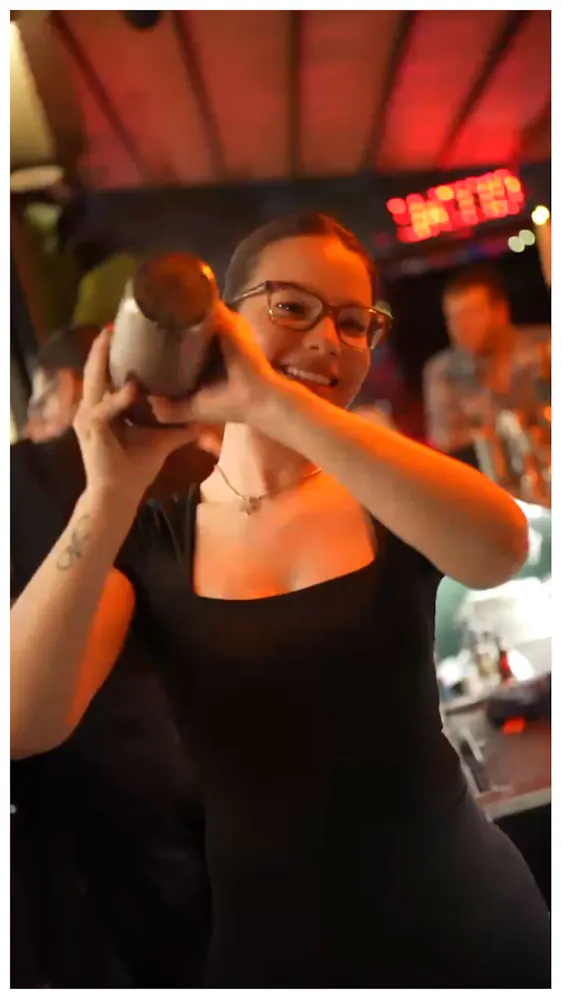 a woman holding a bottle of alcohol