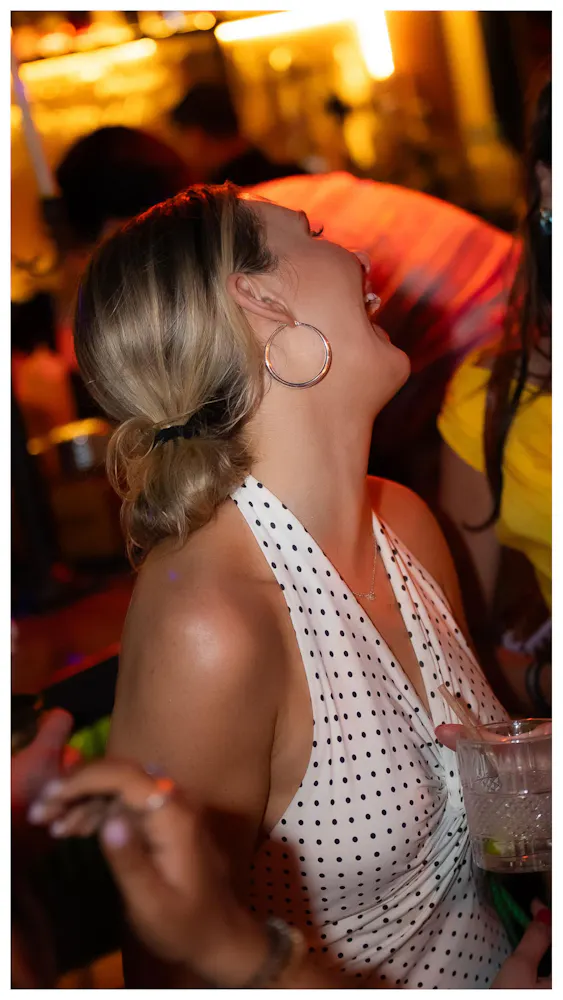 a woman in a white dress with a black and white polka dot top