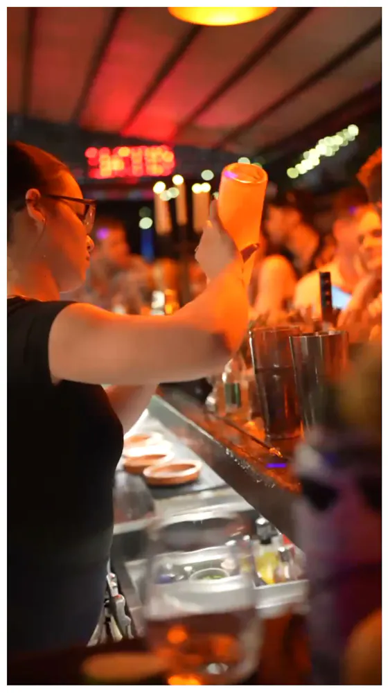 a woman holding a drink