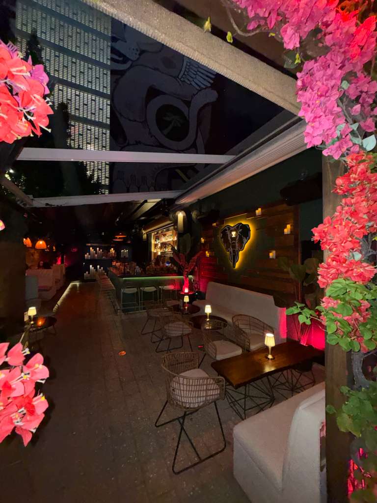 The White Elephant's private event space in Wynwood, Miami — an intimate venue surrounded by florals, warm lighting, and nightlife soul