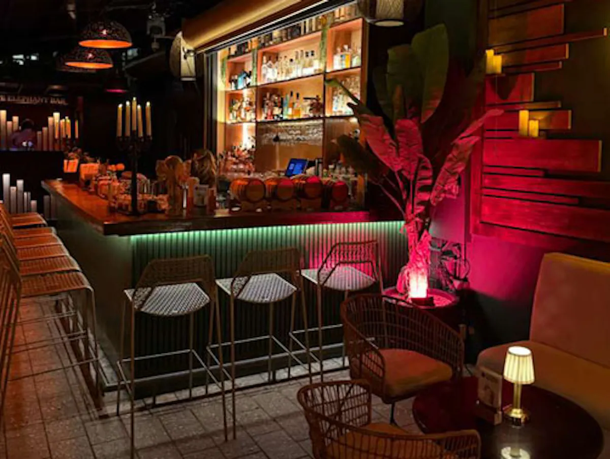 a bar with chairs and tables