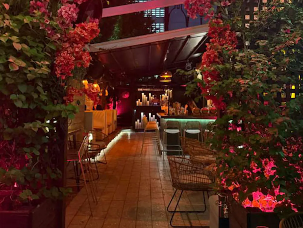a patio with flowers and tables