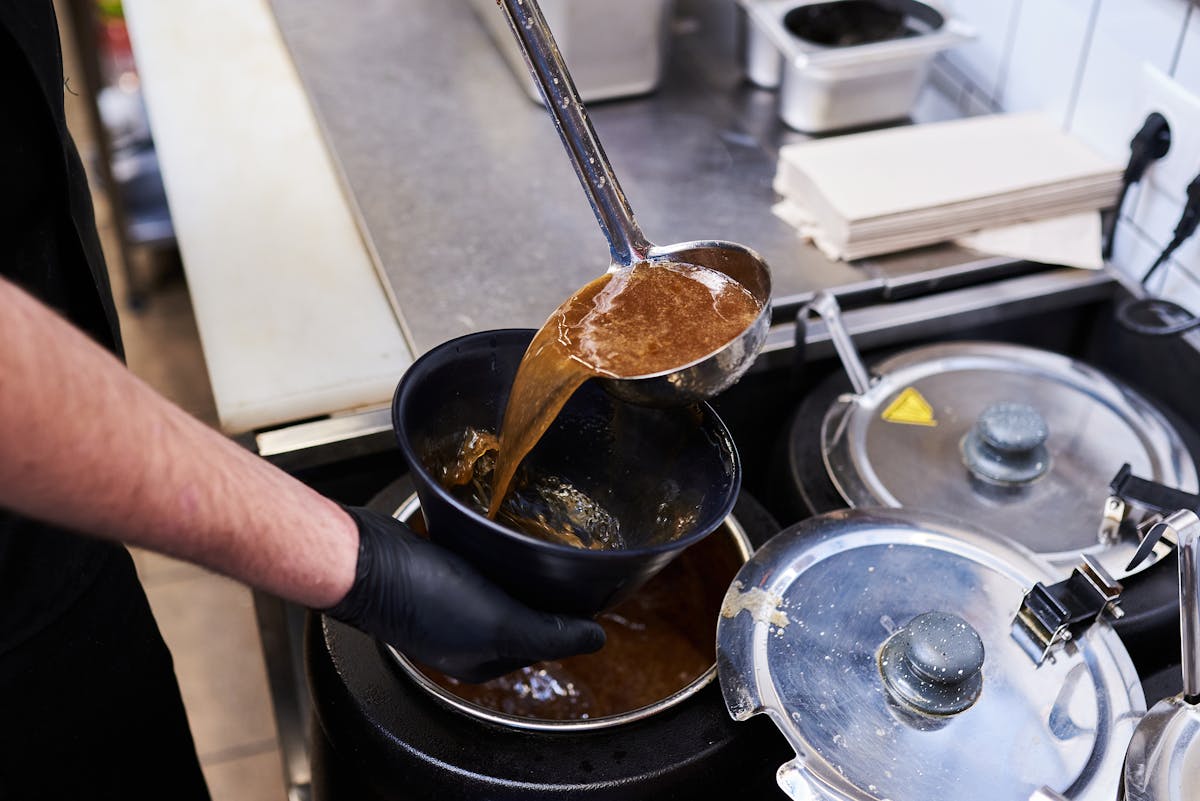 a person in a black pan on a stove