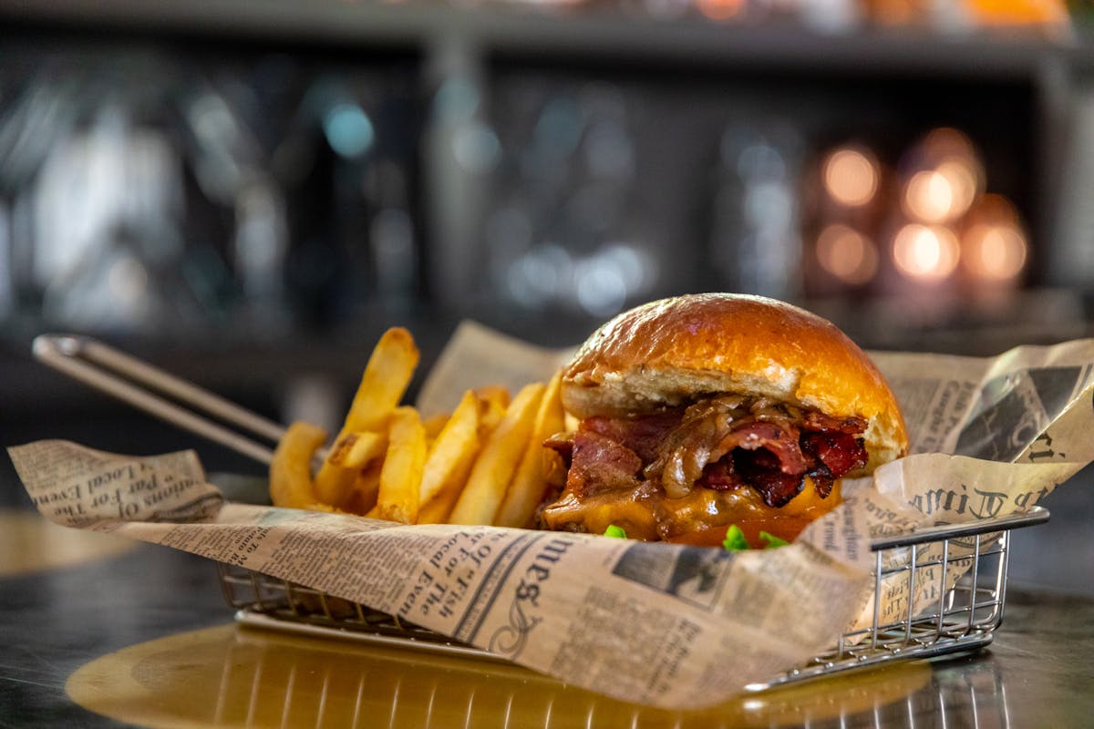 a burger sitting on top of a wooden table