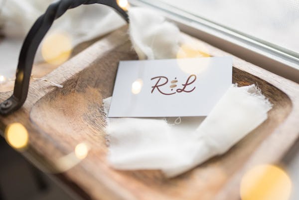 an envelope on a wooden plate