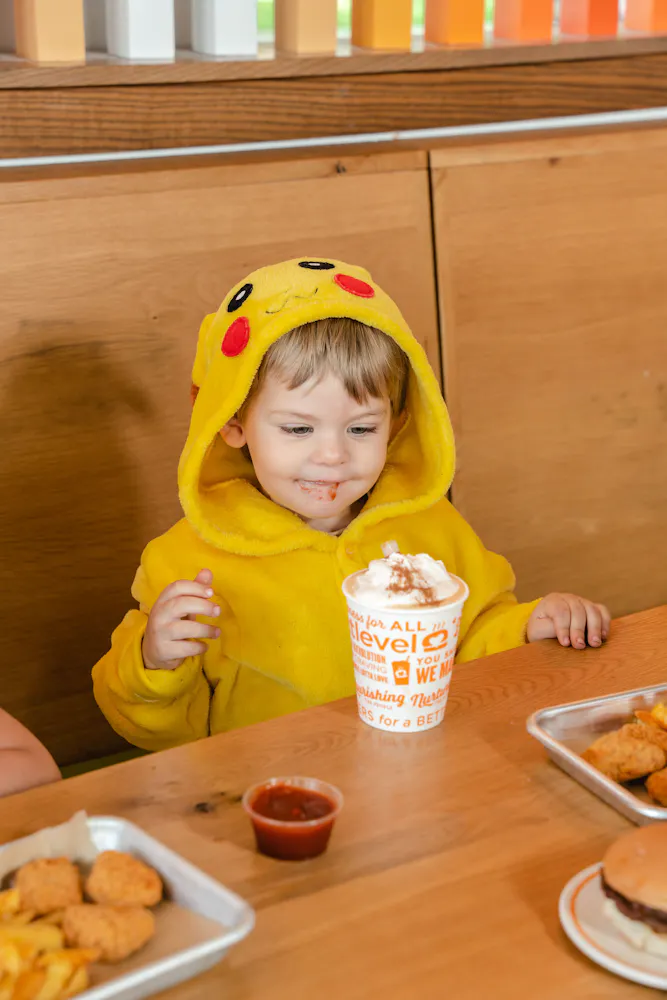 a kid eating chicken nuggets