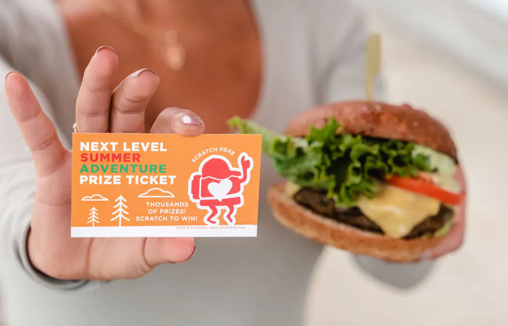 a person holding a burger