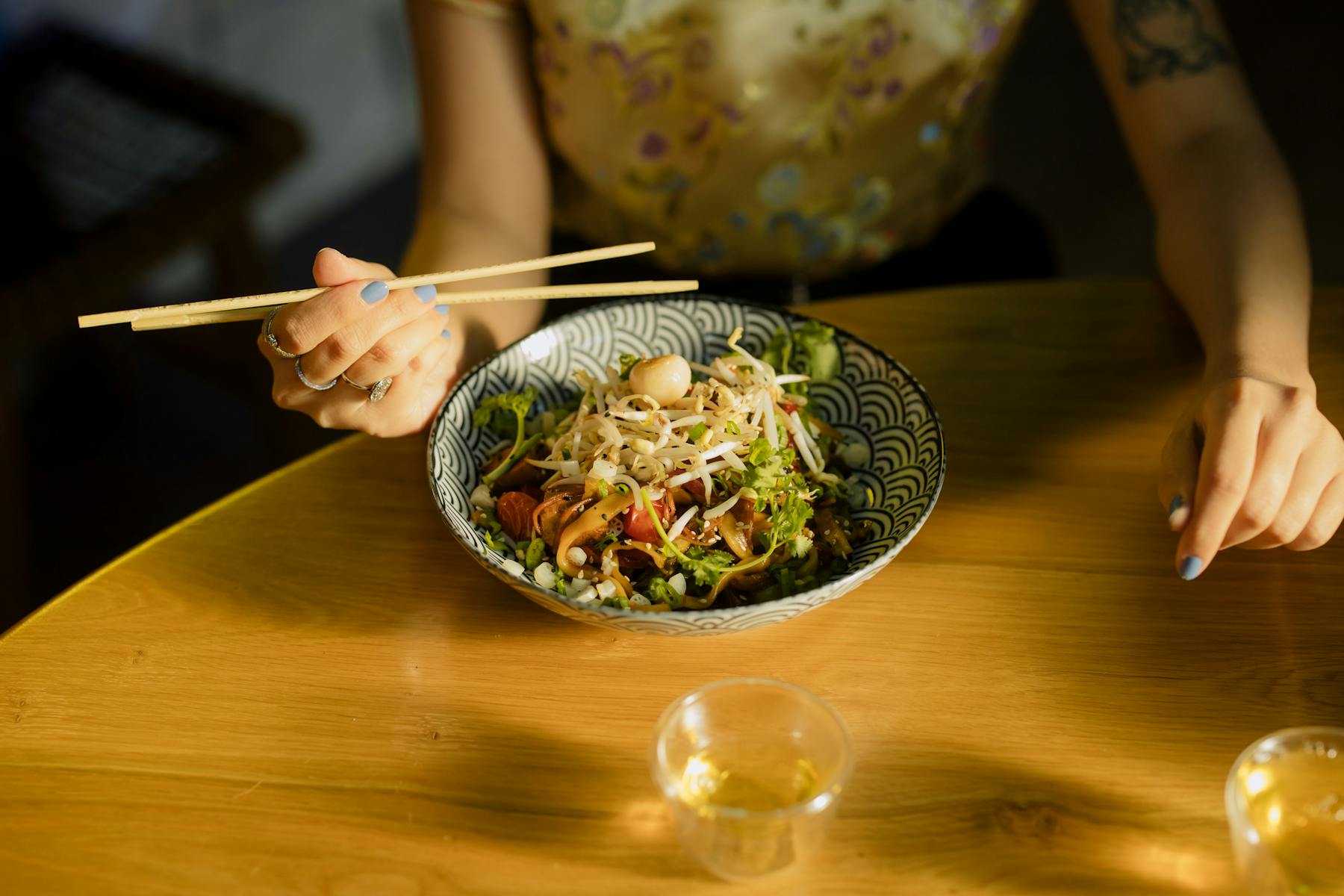 a person sitting at a table with a plate of food