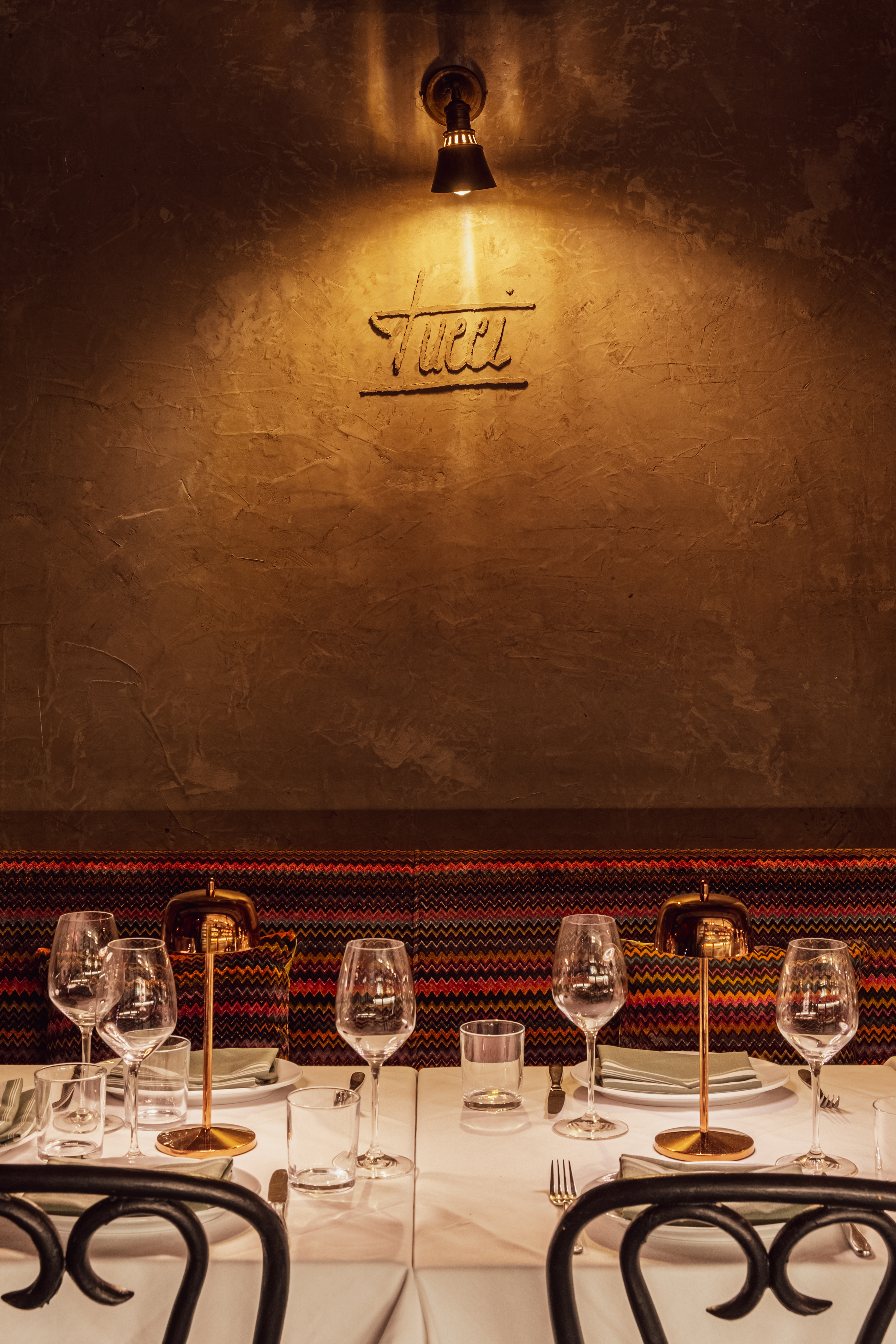Elegant table setting at Tucci NYC with warm lighting and upscale restaurant ambiance for private dining