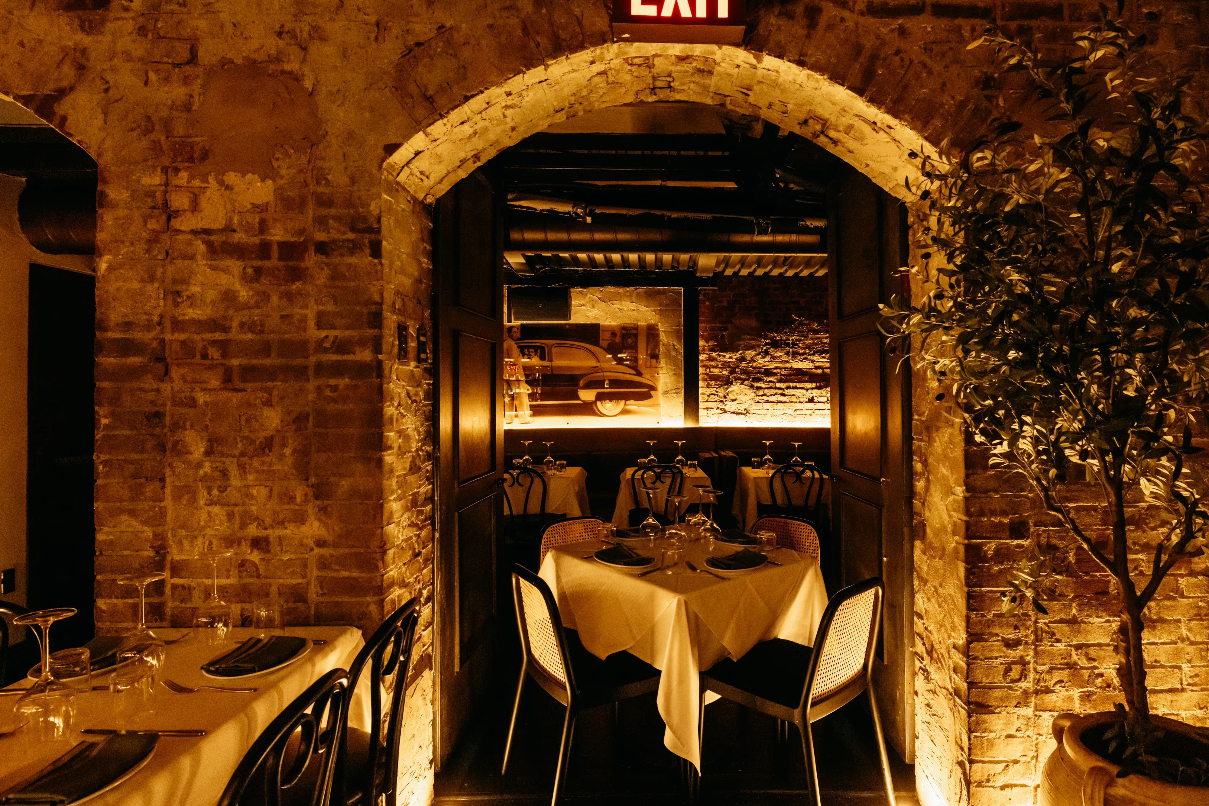 Elegant Tucci NYC dining room with warm lighting, velvet banquettes, and upscale restaurant atmosphere for corporate dining