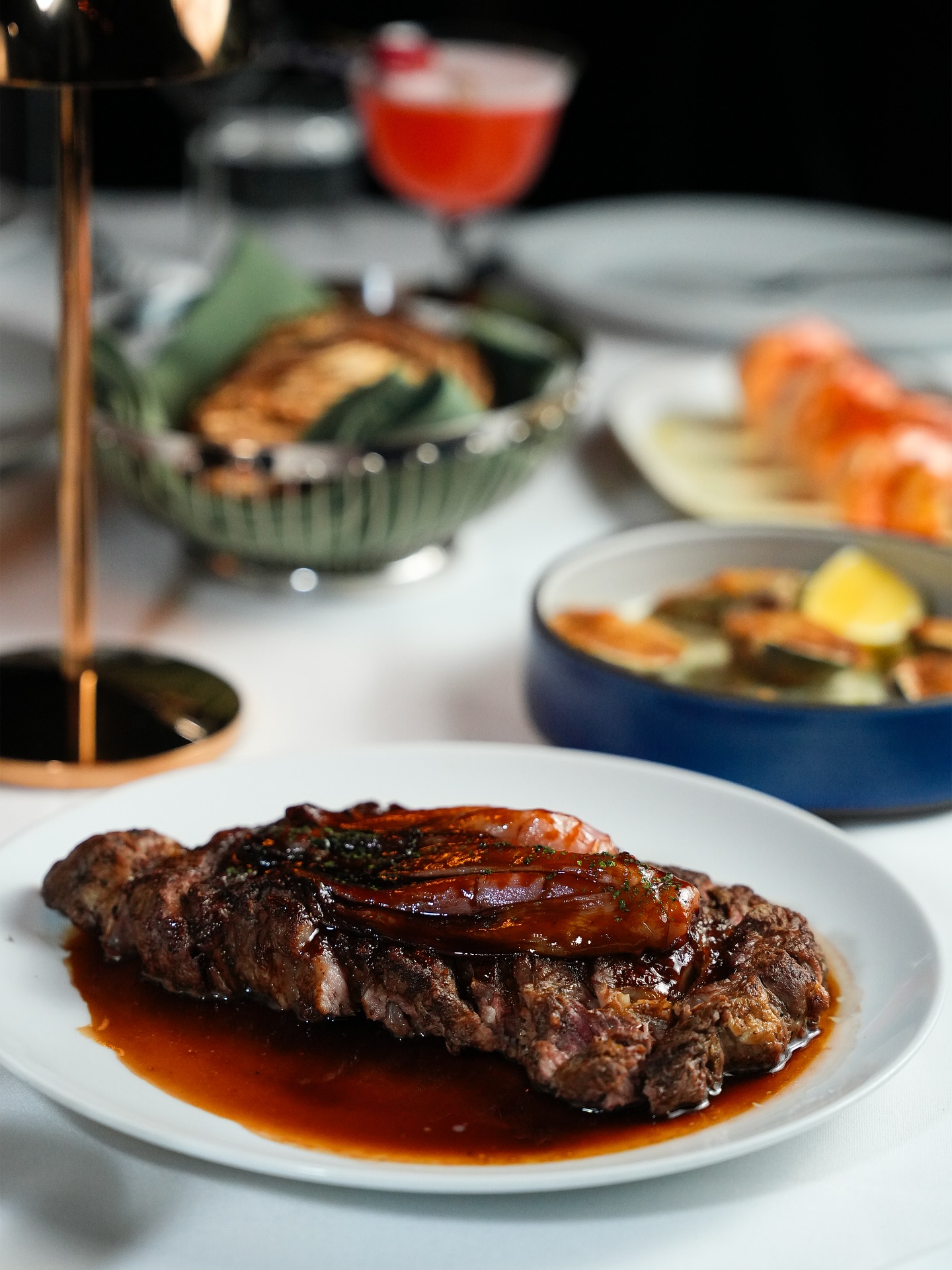 Couple dining at a candlelit two-top inside Tucci NYC's intimate NoHo dining room
