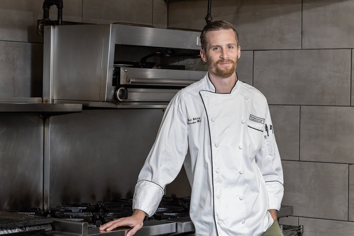 a man standing in a kitchen preparing food