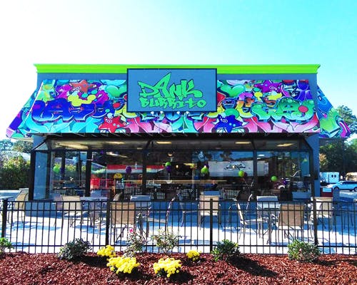 Restaurant from the outside, roof is spray painted with graffiti