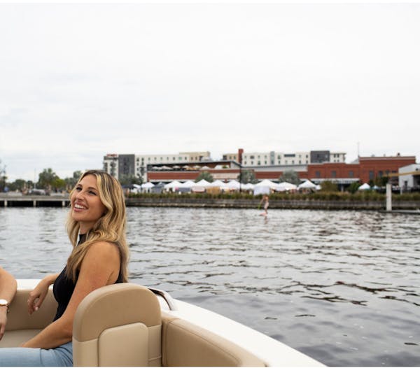 a woman sitting on a boat in a body of water