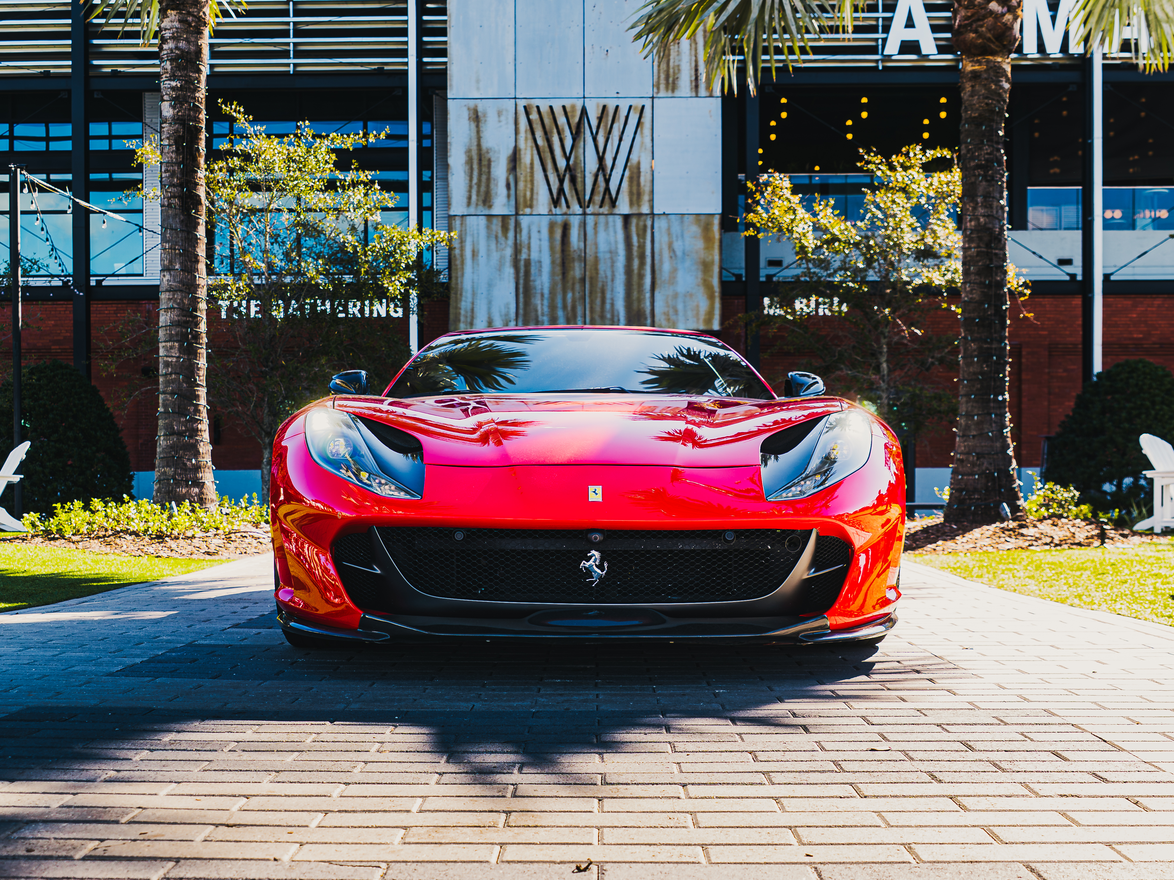 a red sports car parked in front of a building