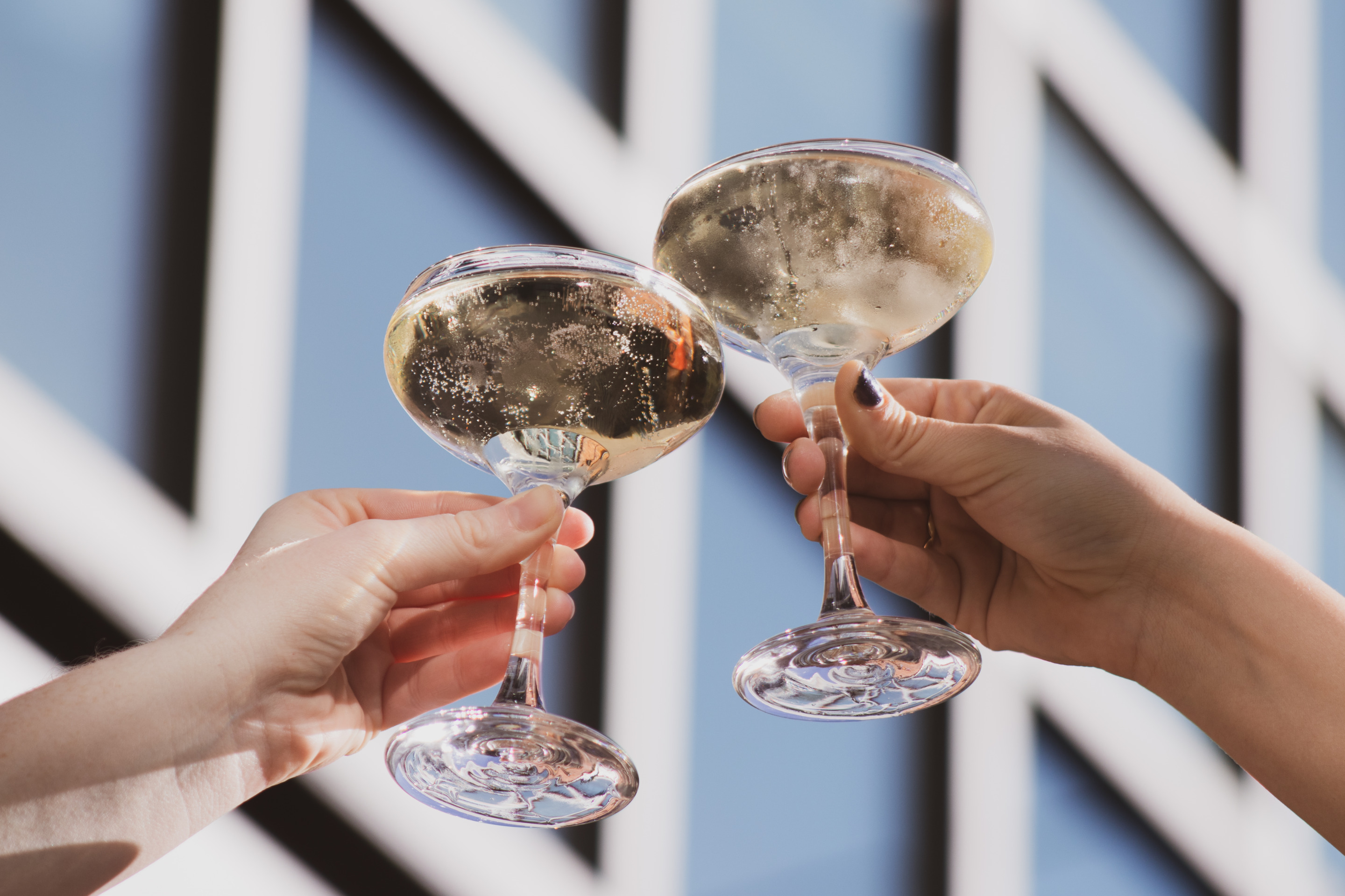 a hand holding a glass of wine