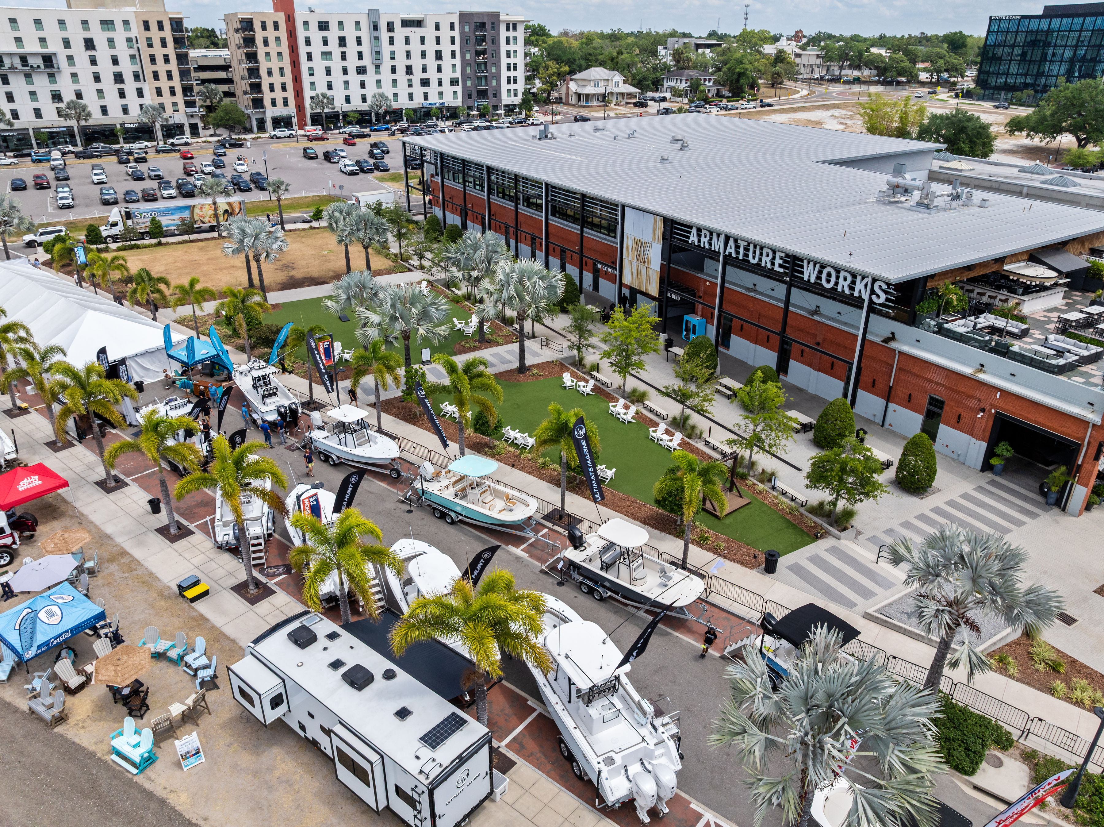 a aerial view of a parking lot with boats and trees