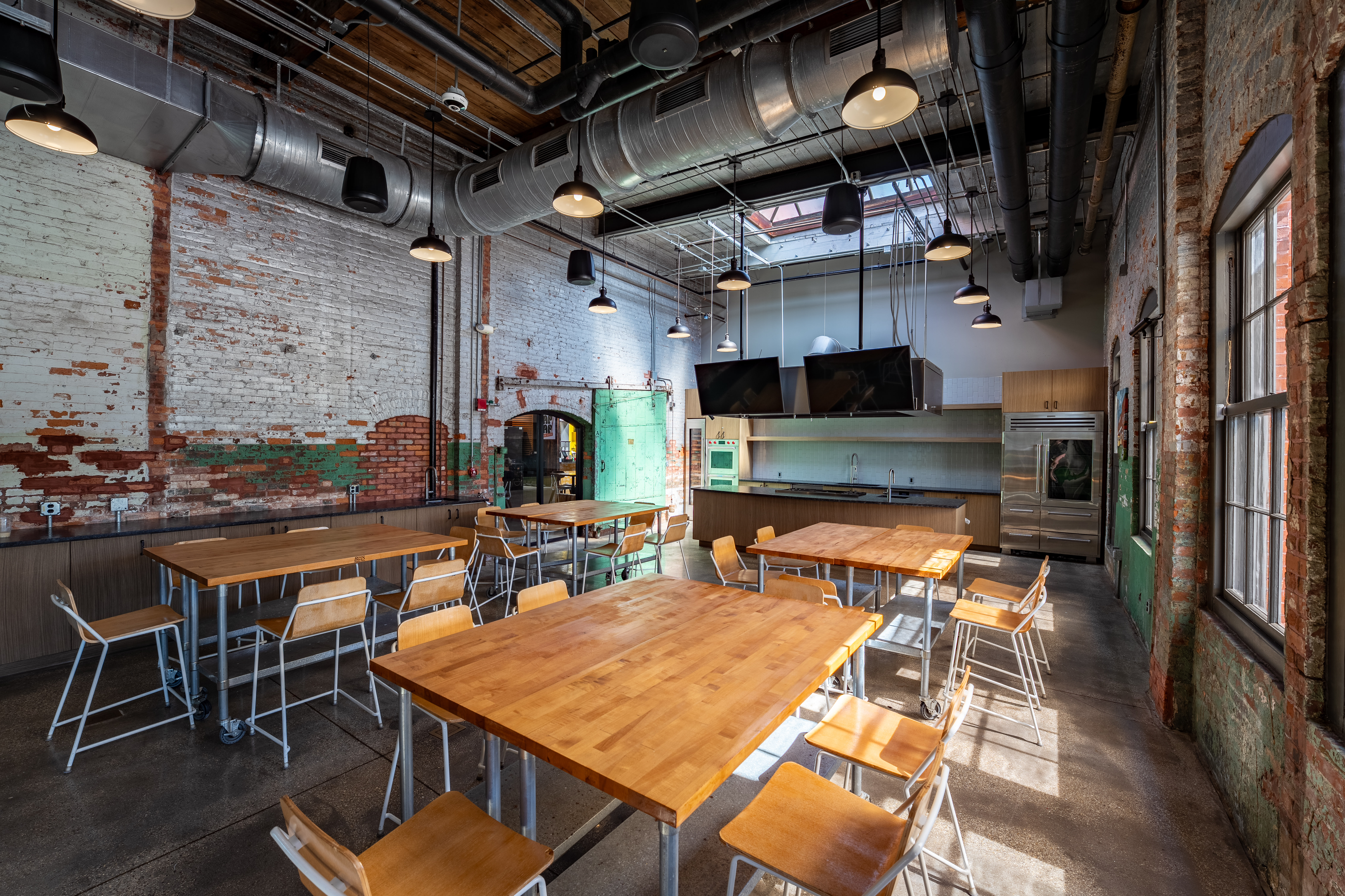 a room filled with furniture and a table in front of a building