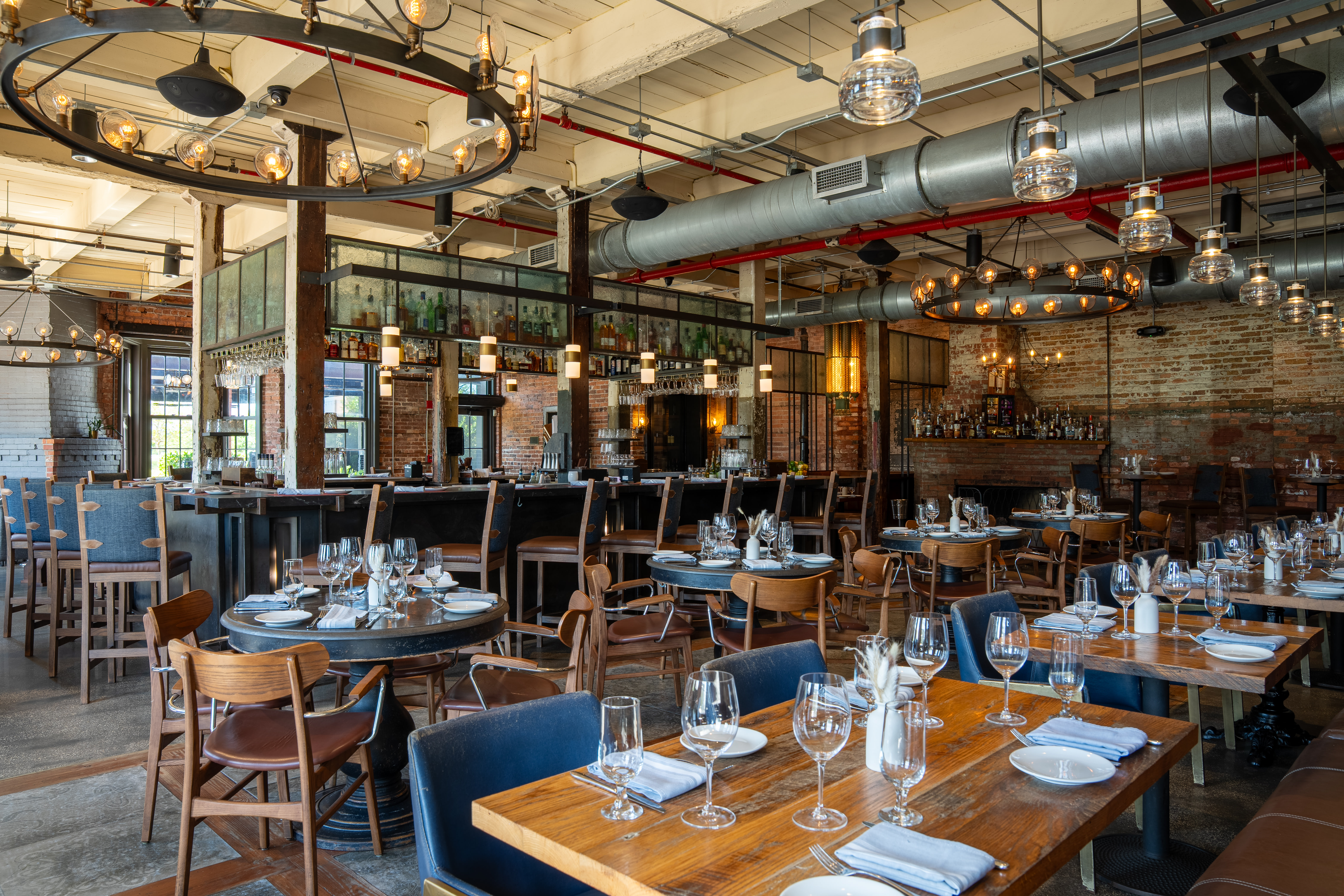a group of people sitting at a table with wine glasses