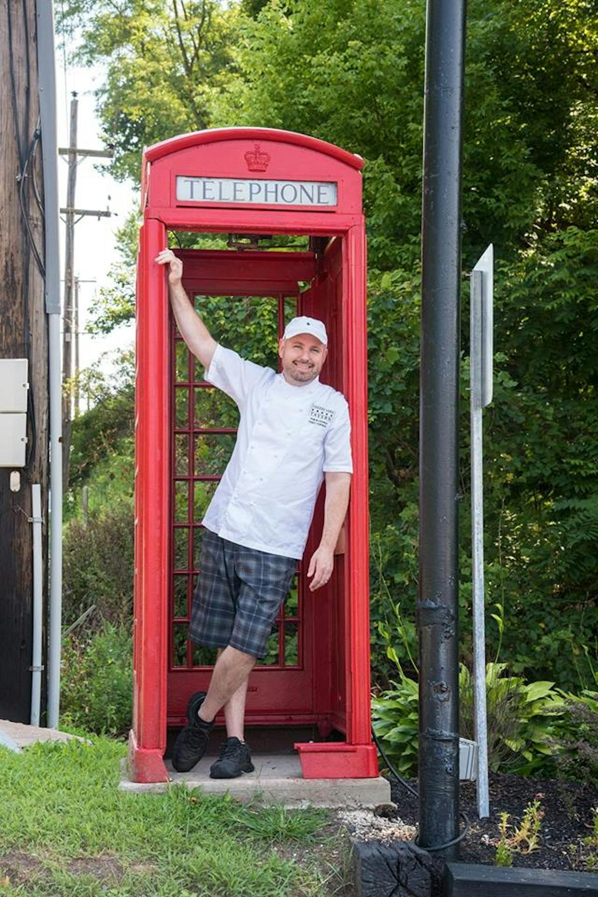 Philip Ferro owner & executive chef in a telephone booth