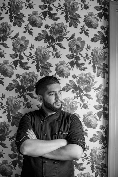 a man standing in front of a mirror posing for the camera