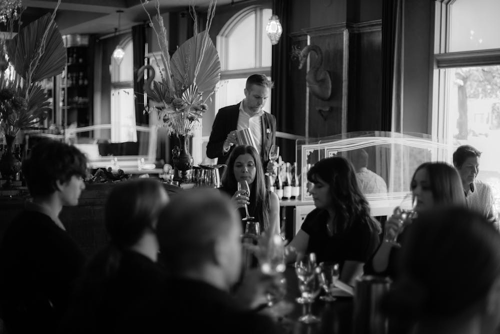 a group of people sitting at a table in a restaurant