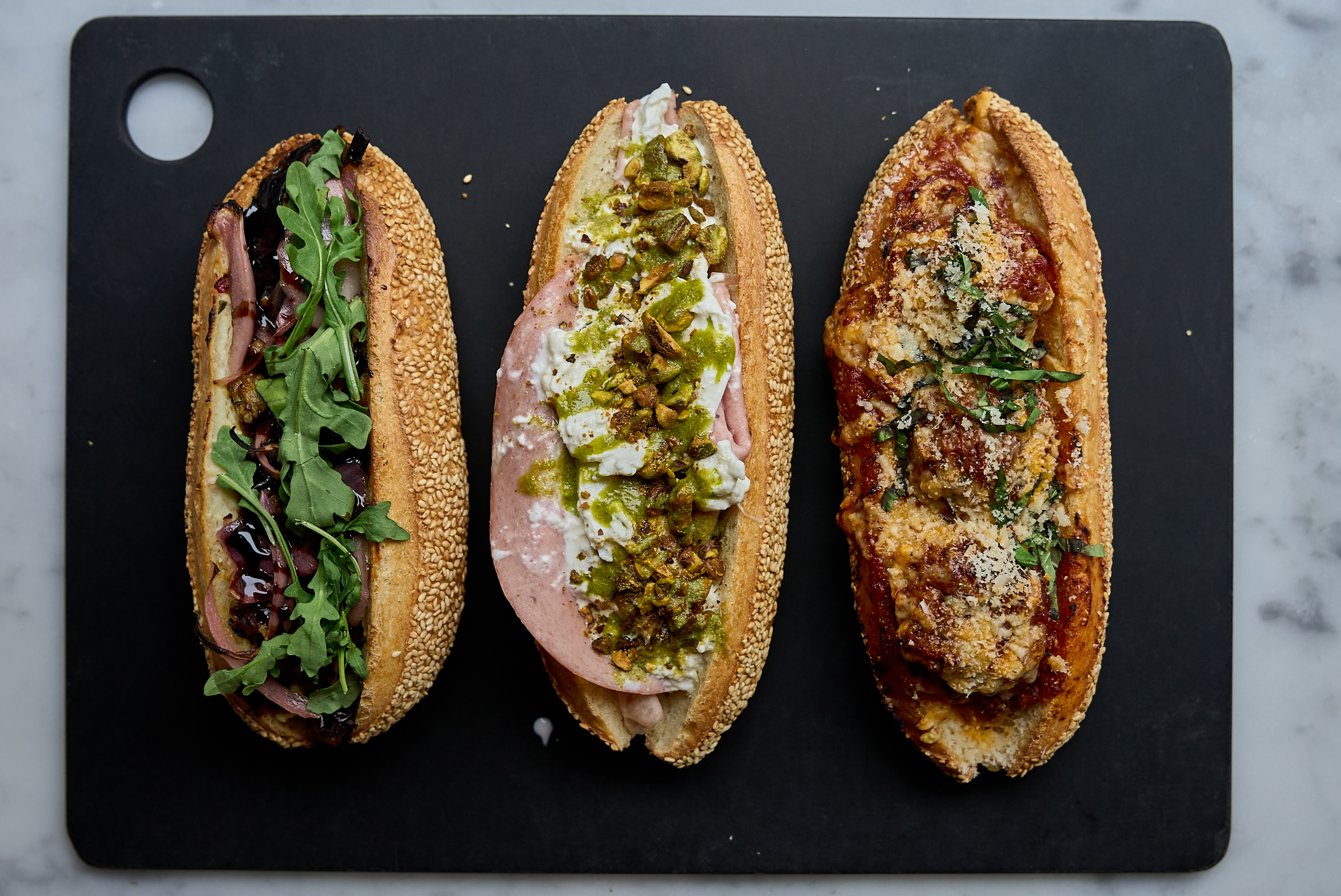 a group of sandwiches on a black surface