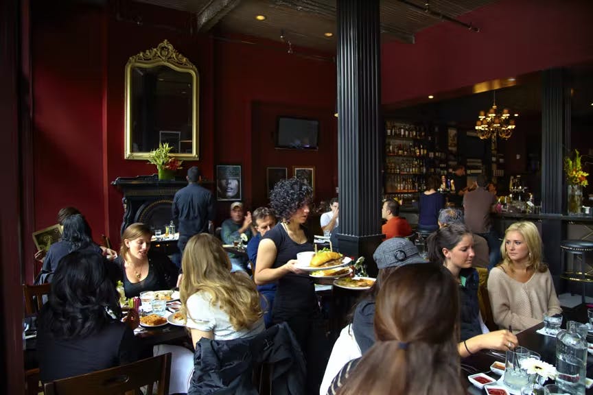 a group of people sitting at a table in a restaurant