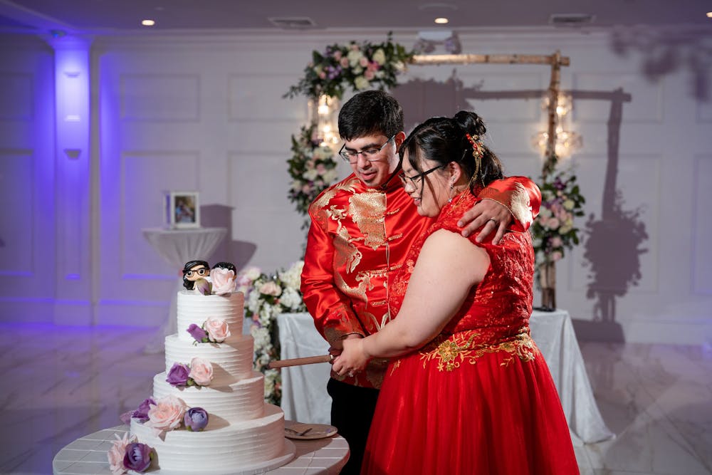 a married couple cutting a cake