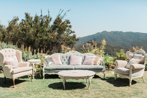 a group of lawn chairs sitting on top of a picnic table