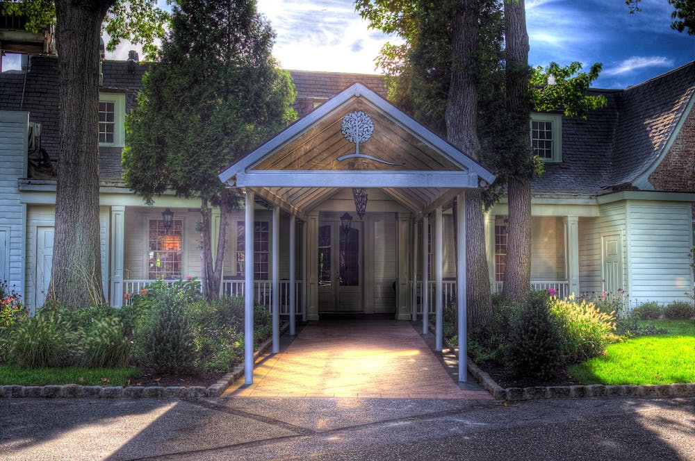 A picture containing outdoor, building, plant, sky
Description automatically generated