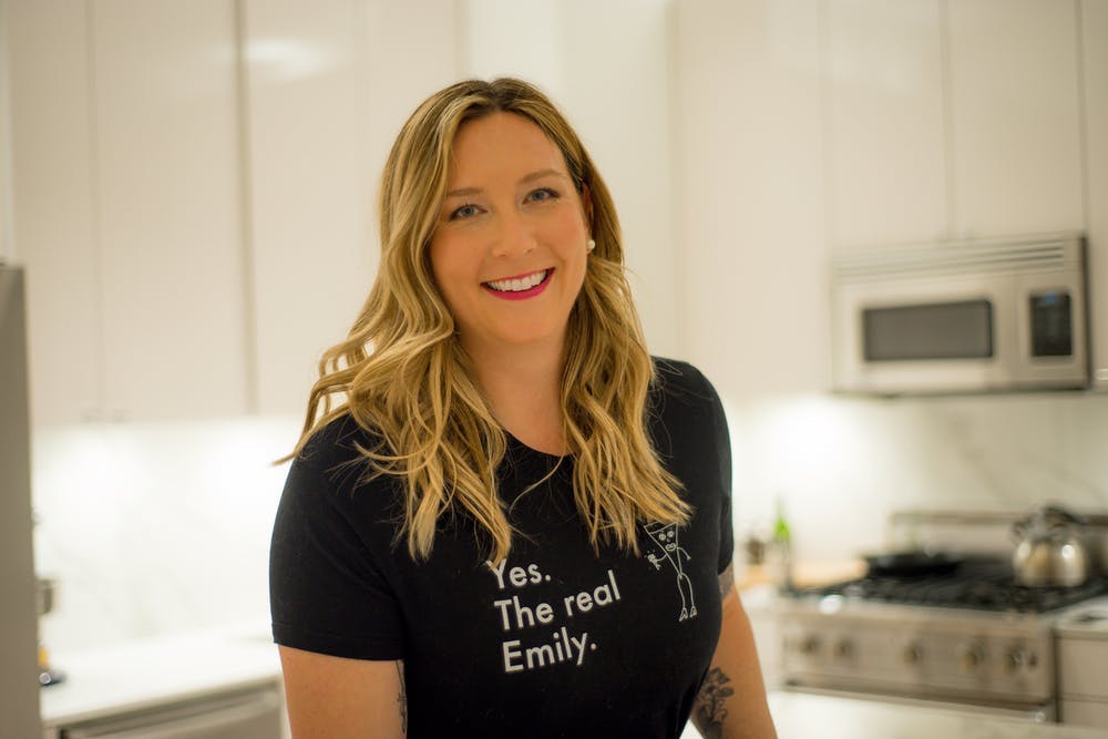 a woman standing in a kitchen