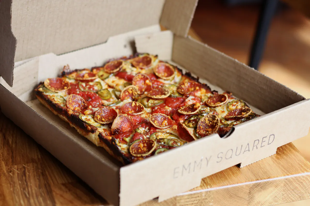 a pizza sitting on top of a wooden box