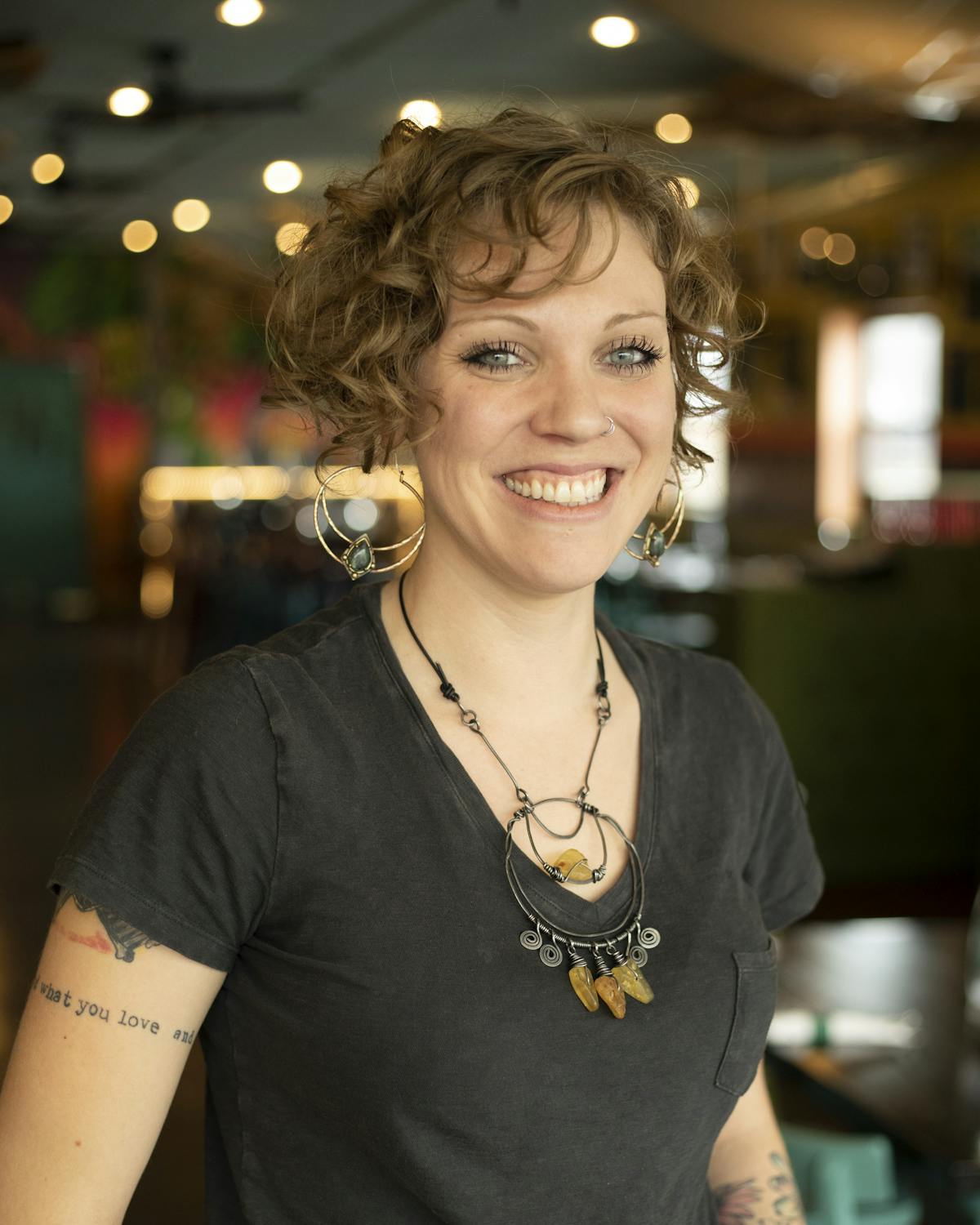 a woman wearing glasses and smiling at the camera