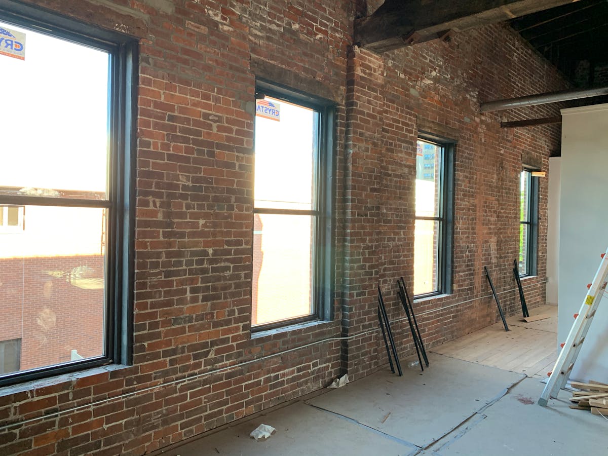 a room with brick walls and a large window