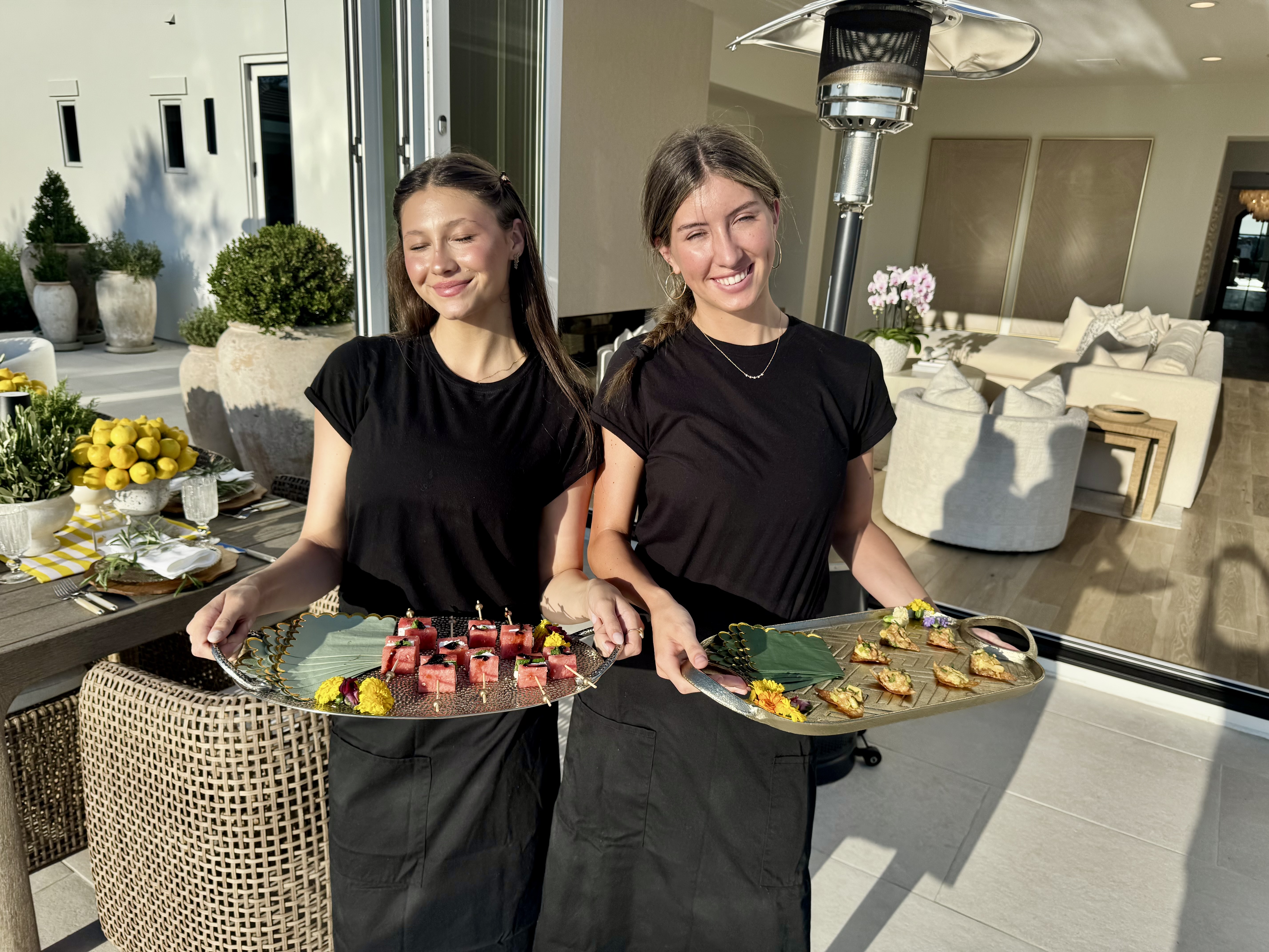 a person standing by a table with food
