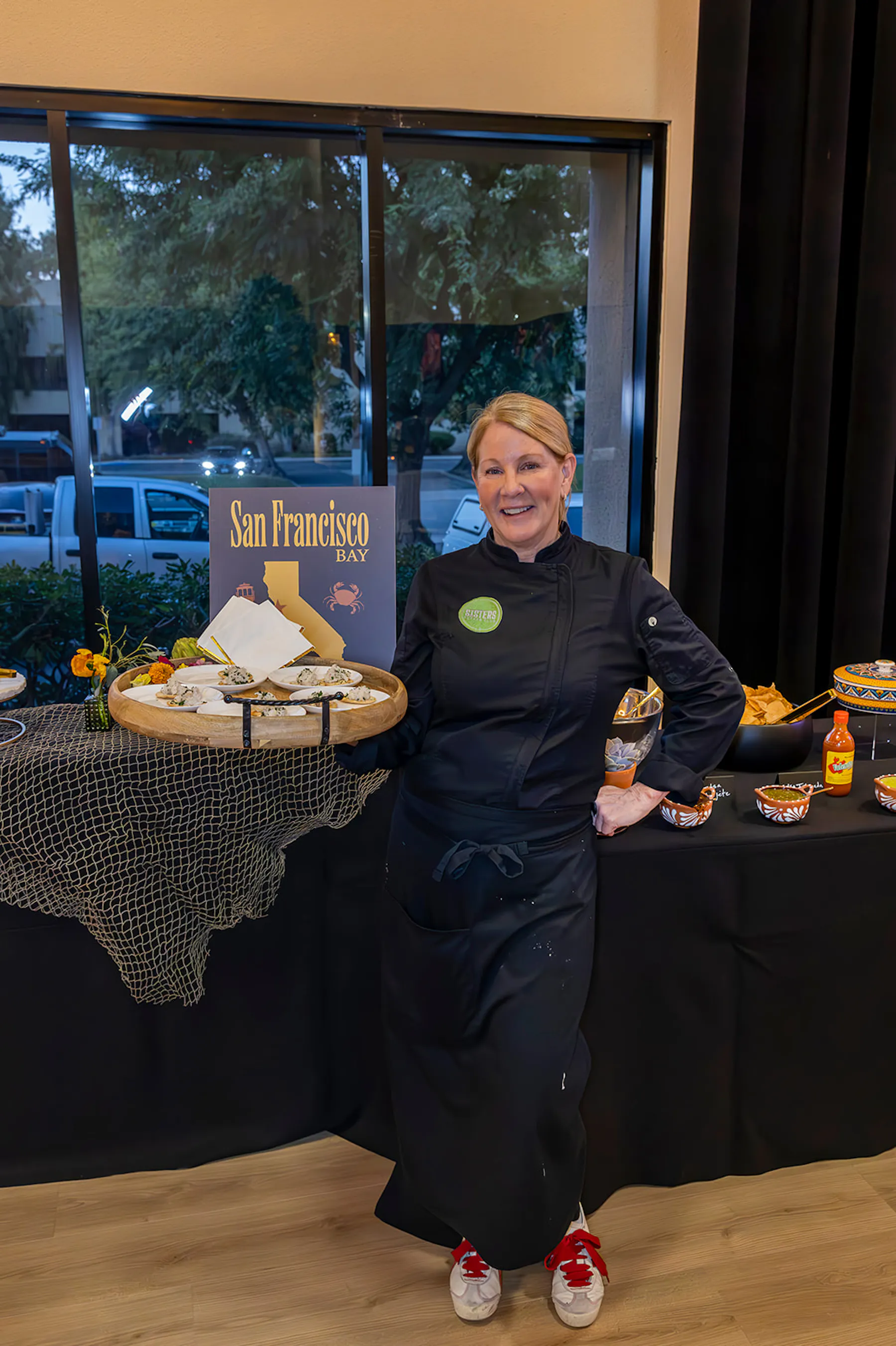 a person standing in front of a cake