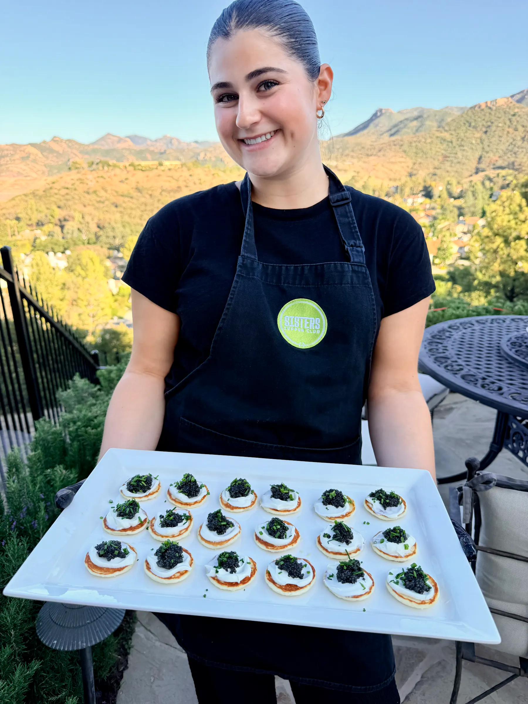 a woman holding a tray of food