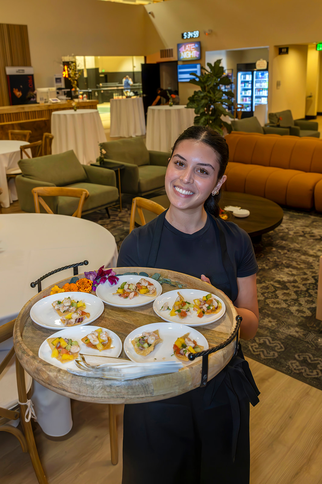 a person sitting at a table with a cake on a plate