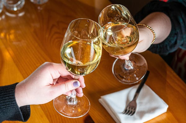 a hand holding a glass of wine