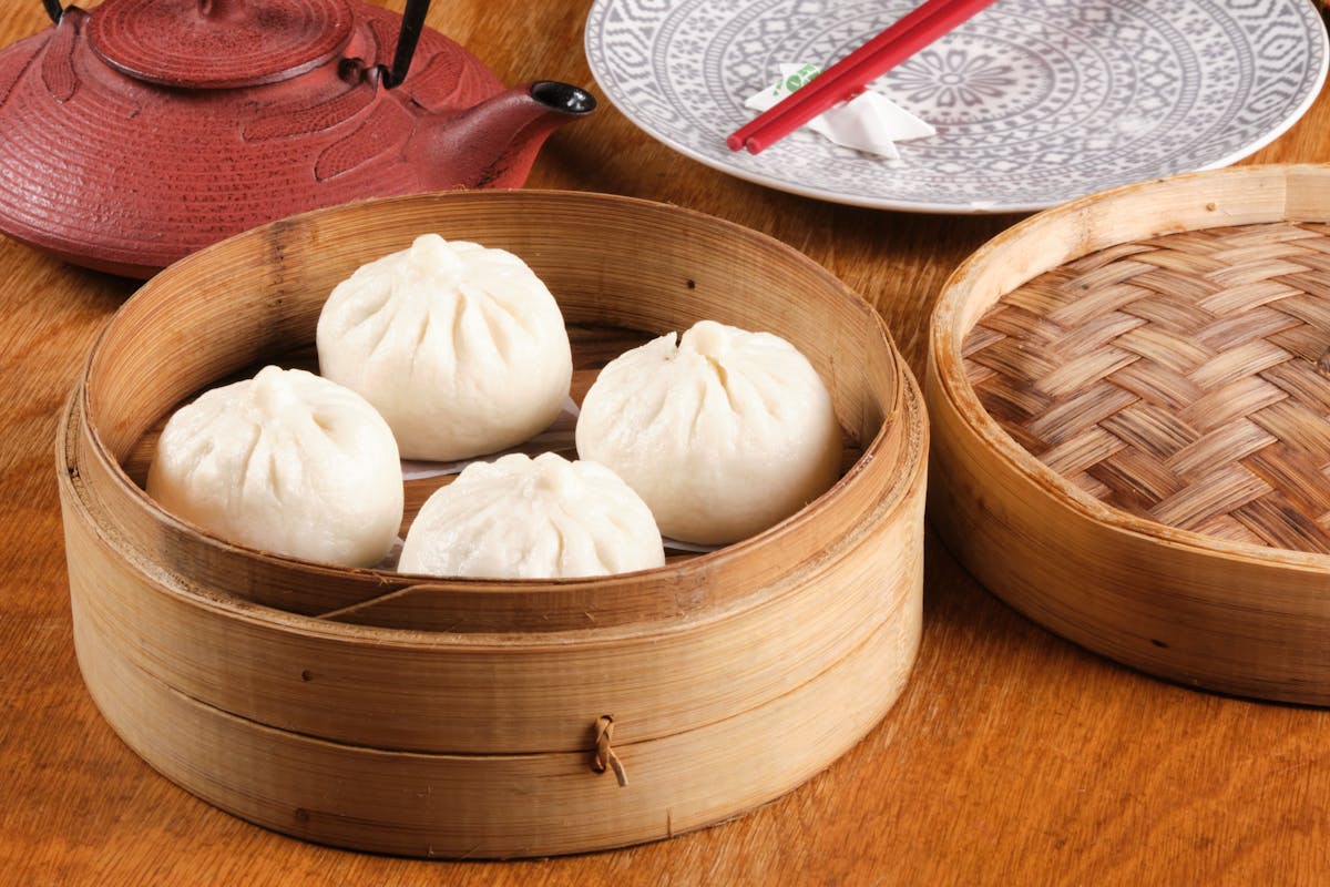 a bowl of food sitting on top of a wooden table