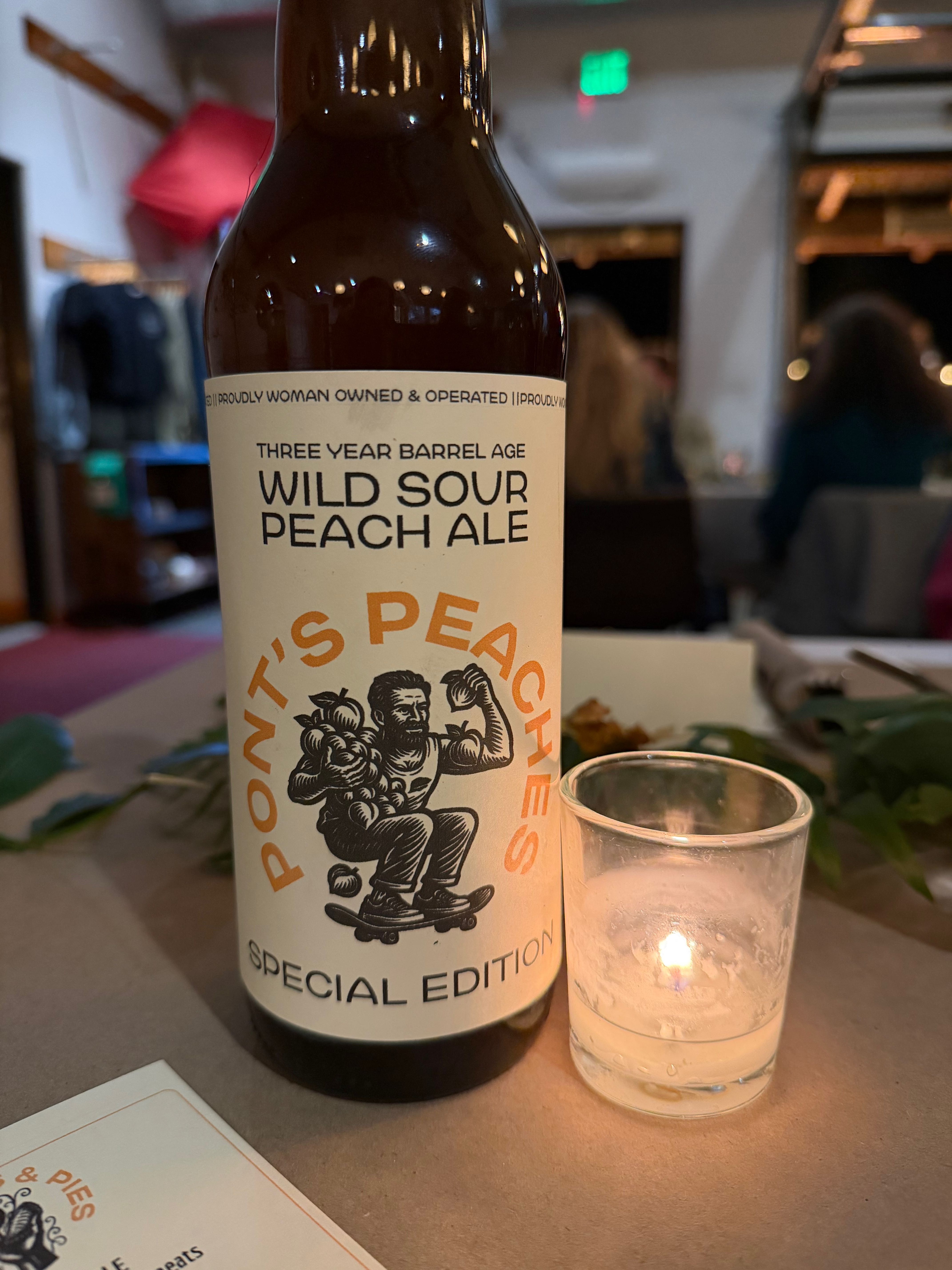 a bottle of wine and a glass of beer on a table