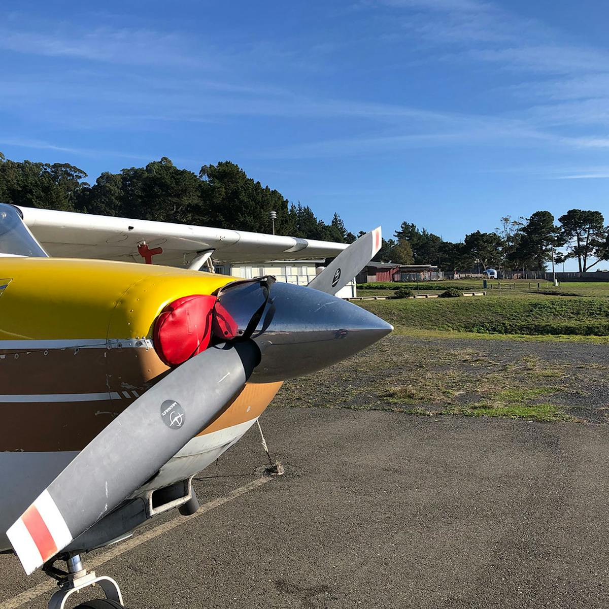 a propeller plane sitting on top of a runway