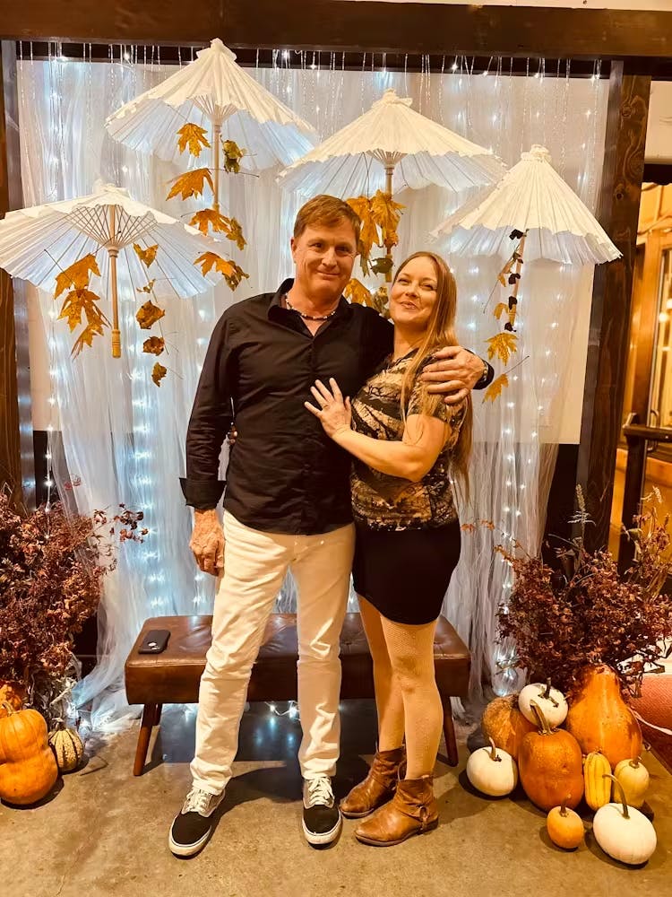 a man and a woman standing in front of a building