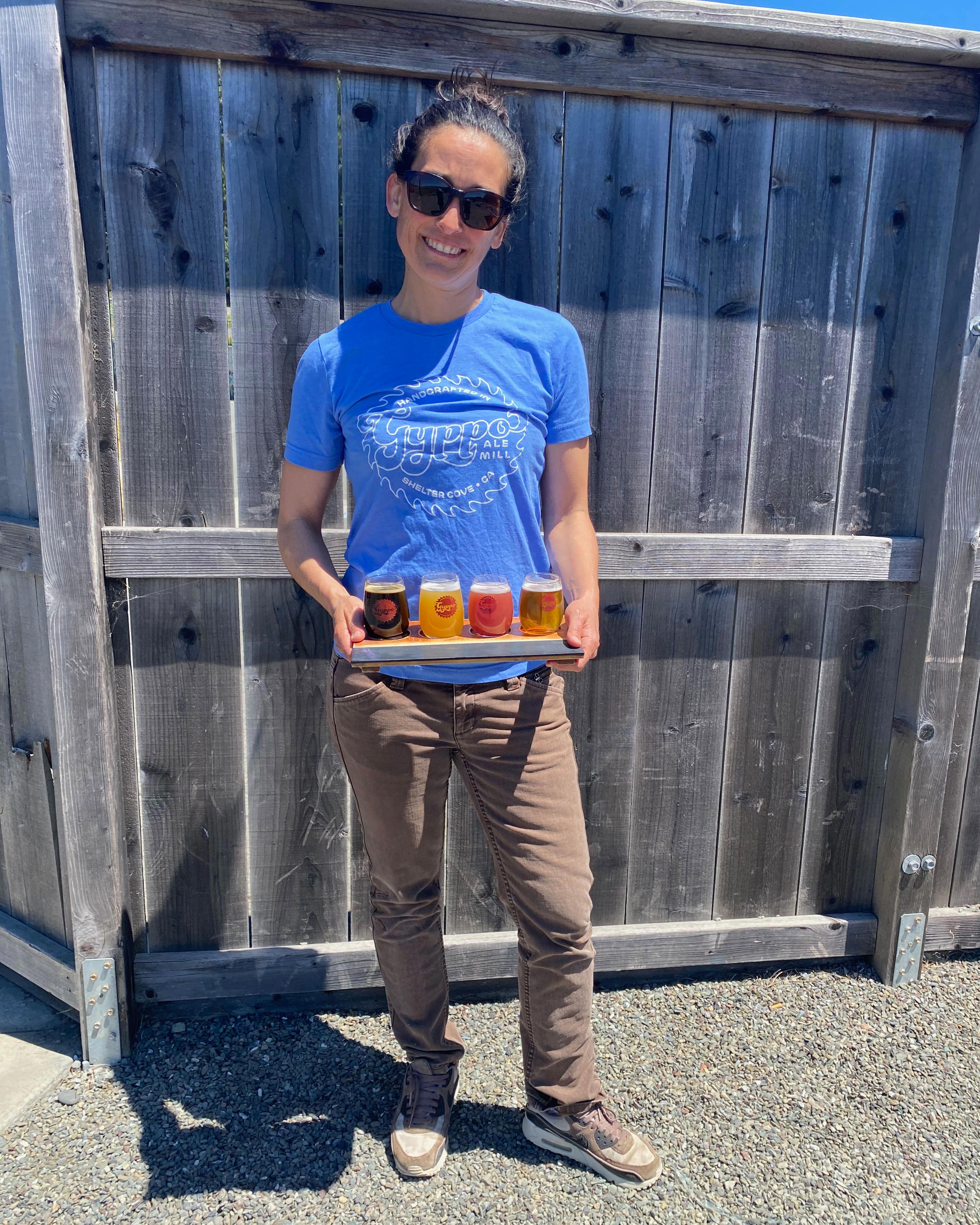 a woman holding a tray of beer