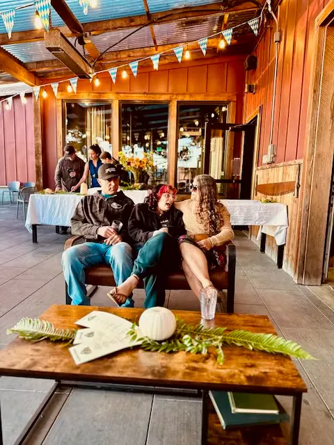 a group of people sitting on a bench outside