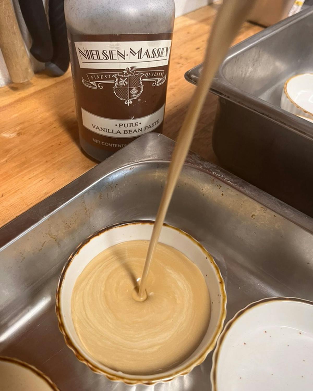 a cup of tea sitting on top of a pan on a table