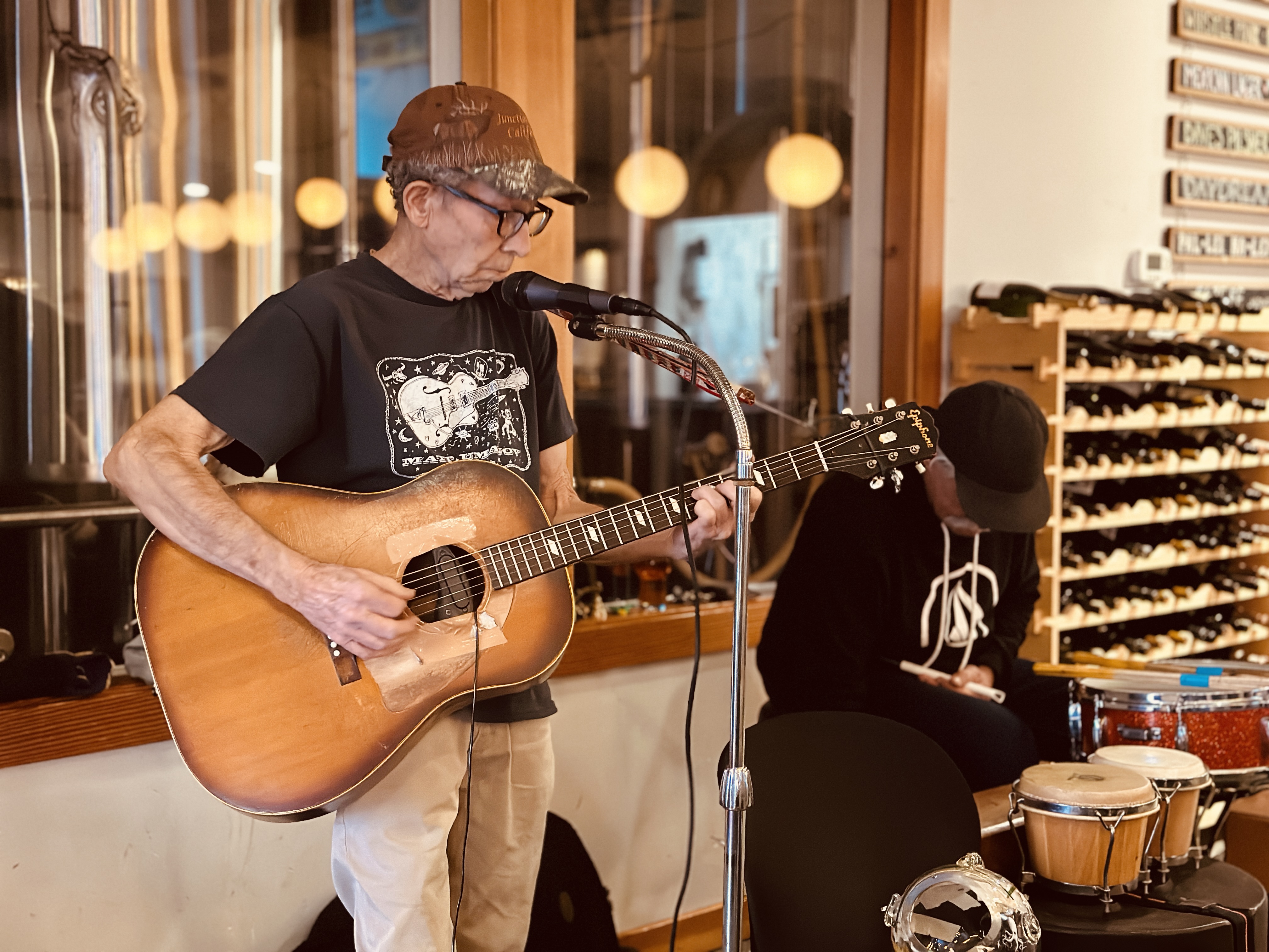 a man playing guitar in a room