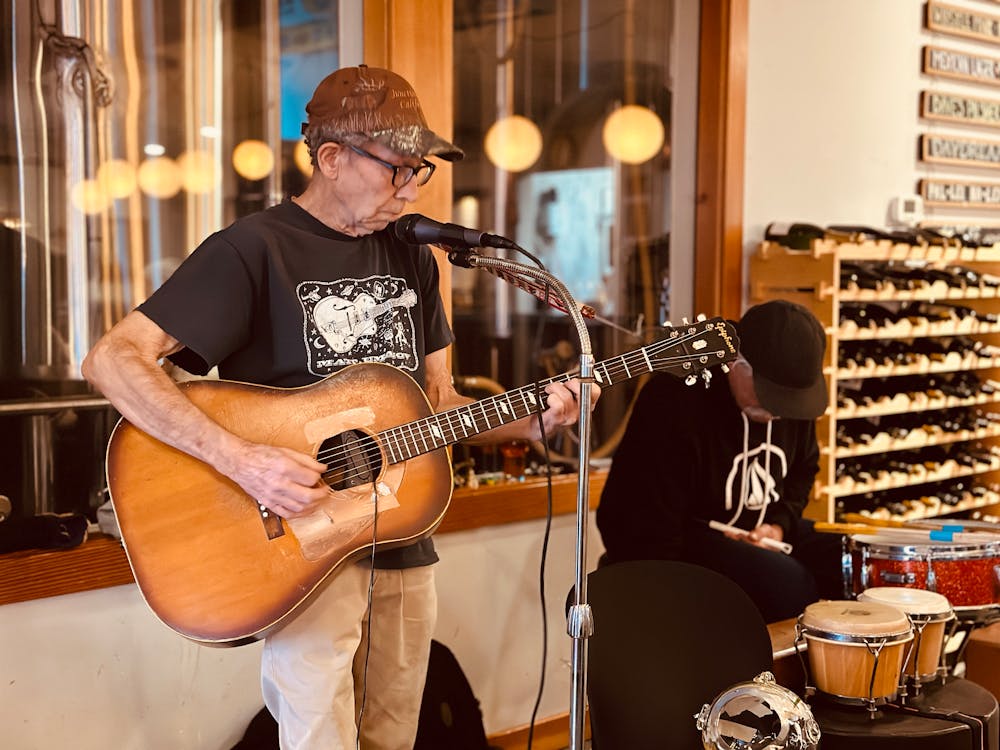 a man playing guitar in a room